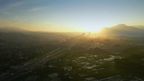 Aerial Sunrise Shot of the Cileunyi Interchange, Bandung, Showing Complex Highway Overpasses and Urban Fog Under Golden Light - Powered by Shutterstock - Get 15% off with code: PIKWIZARD15