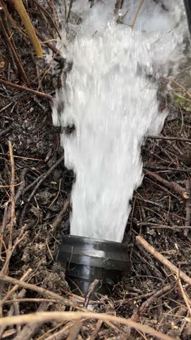 High-Pressure Water Flowing from Pipe for Irrigation – 4K Vertical Video
