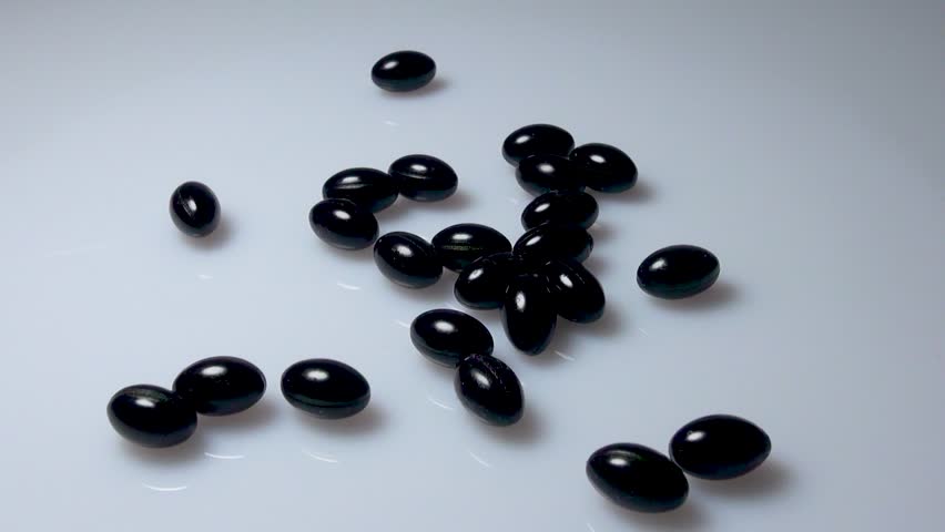 Black capsules in the form of tablets