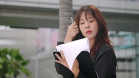 Young business businesswoman happy, modern office travel walking outdoor professional woman smiles holding important papers reviewing work outdoors near contemporary city buildings. - Powered by Shutterstock - Get 15% off with code: PIKWIZARD15