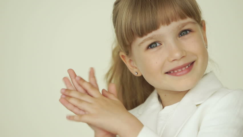 Little businesswoman clapping her hands and smiling
