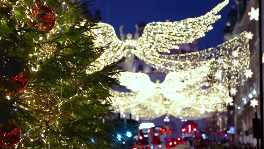 Festive christmas decorations on lower Regent Street, Central London, England, with a Christmas tree and street lights