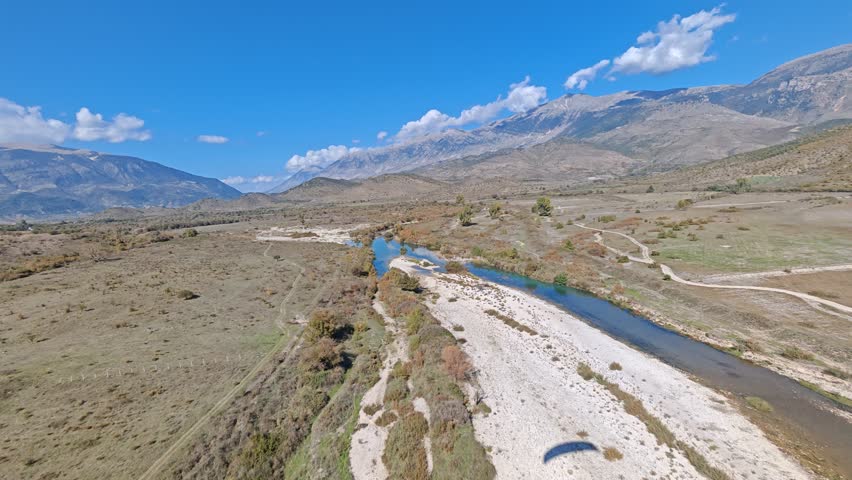 Aerial view of Albania scenic mountains, valleys, and untouched nature. Rugged terrain with lush greenery and dramatic elevation under clear skies