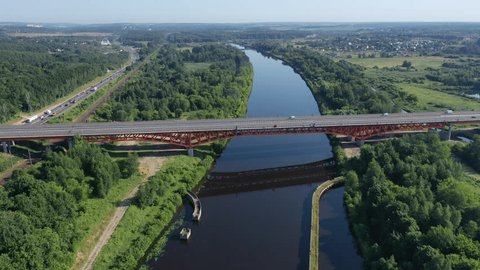 Drone Rising beside Elevated Bridge over Calm