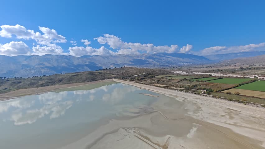 Aerial view of Albania scenic mountains, valleys, and untouched nature. Rugged terrain with lush greenery and dramatic elevation under clear skies