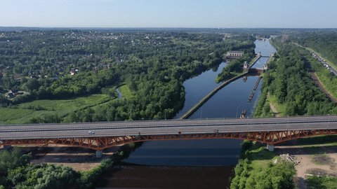 Drone Moving over Highway Bridge toward Forest