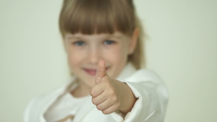Cute girl with ok hand thumbs up sign smiling
