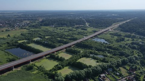 Rotating Flight above Highway Bridge River Landscape