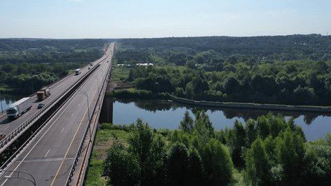 Drone Glides across Highway Bridge While Rotating
