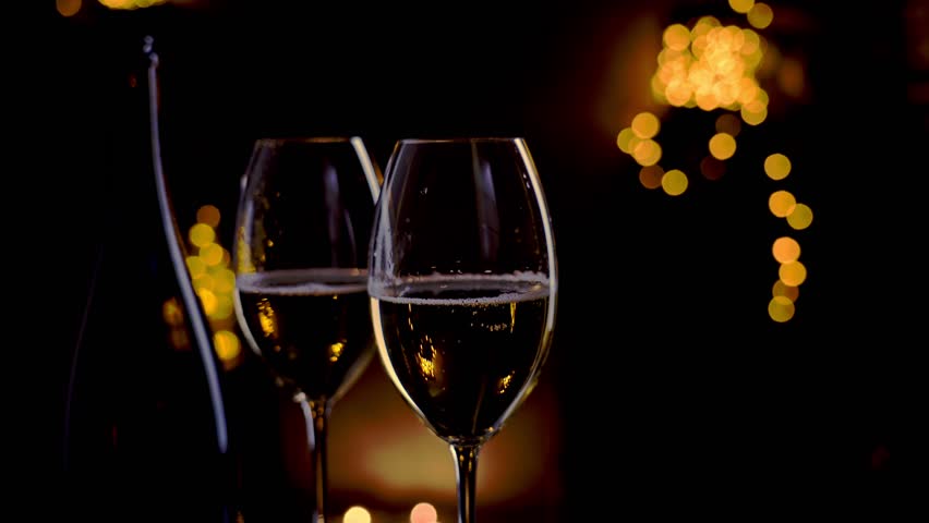 Champagne in glass, sparkling wine and lights. Celebrating the Happy New Year.