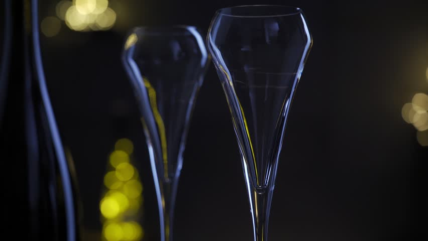 Pouring champagne to glass, sparkling wine and lights. Celebrating the Happy New Year.