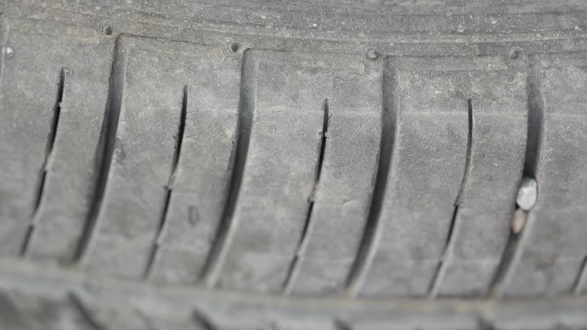 Inspecting tire tread and checking for damage