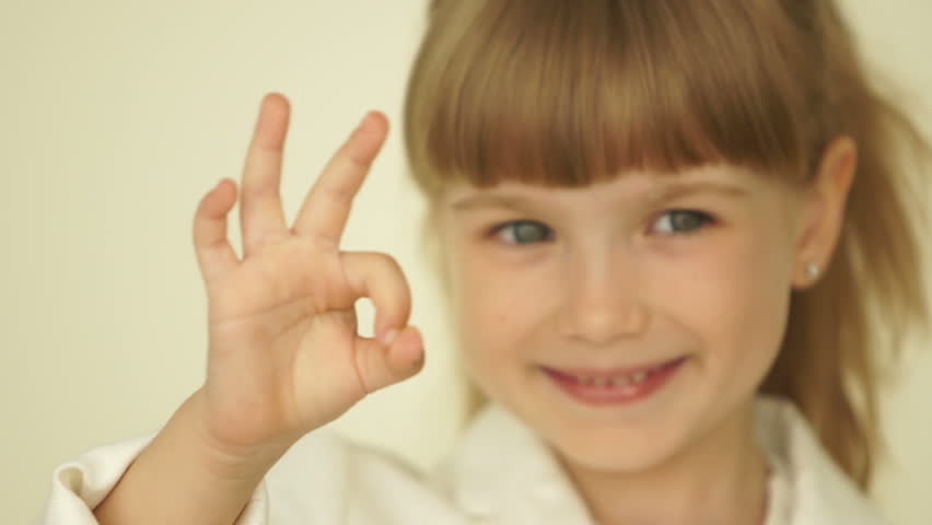 Little girl with ok hands sign. Slowmotion
