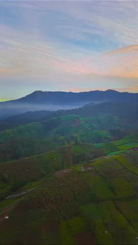 Scenic Mountain Landscape at Sunrise Over Green Farmlands