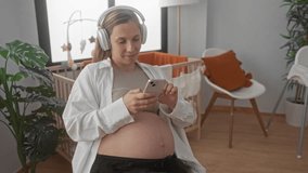 Pregnant woman wearing headphones relaxes with smartphone in cozy baby room, surrounded by crib, plants, and soft furnishings, creating a serene and expectant atmosphere. - Powered by Shutterstock - Get 15% off with code: PIKWIZARD15