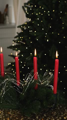 Four lighted candles blowing out with Christmas tree decoration. Hanukkah. Holidays and religion.