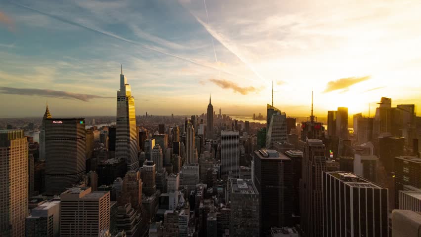 New York. Aerial view of New York City during sunset, with skyscrapers silhouetted against a golden sky.