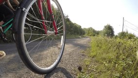 Low-angle shot of a couple cycling along a forest trail, capturing outdoor adventure, healthy lifestyle, and connection with nature. - Powered by Shutterstock - Get 15% off with code: PIKWIZARD15