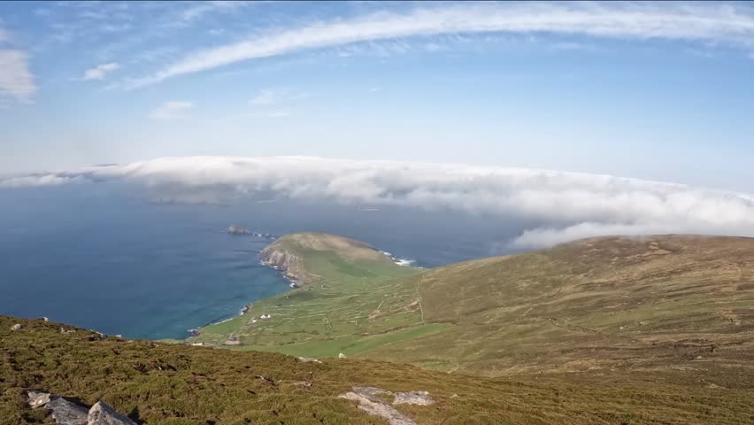 moving clouds over the ocean at dunmore head, slea head drive, dingle peninsula