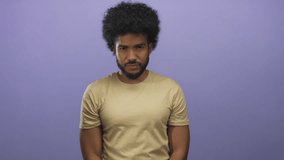 African american man making a vigilant gesture against a purple background, isolated, conveying a serious watchful demeanor with his hand, wearing a smartwatch, neutral expression. - Powered by Shutterstock - Get 15% off with code: PIKWIZARD15