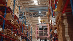 Two warehouse employees on a lifting platform inspect high pallet racks in a distribution facility, evaluating stock and planning logistics operations.
 - Powered by Shutterstock - Get 15% off with code: PIKWIZARD15