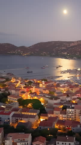 scenic aerial perspective of calm coastal town featuring bright rooftops and gentle bay waters. Porto-Vecchio. France