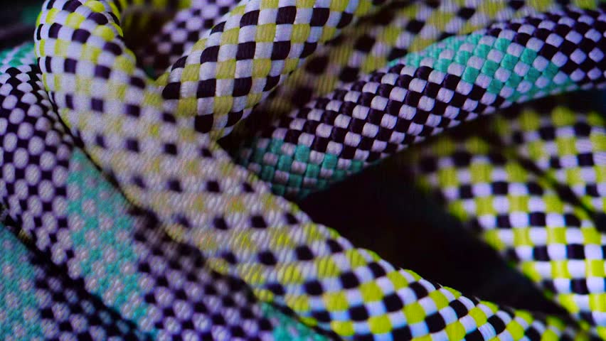 Multicolored climbing ropes. Mountaineering, static ropes, cord, paracord, sports, recreation, mountain equipment. Rotation. Yellow, green, white, climbing, personal protective equipment.