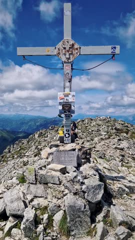 Rugged Mountain Ridge with Cloudy Sky in the Distance

