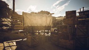 A classic covered wagon sits in a rustic settlement surrounded by wooden crates and pallets under a warm late afternoon sun, evoking a sense of adventure and history. - Powered by Shutterstock - Get 15% off with code: PIKWIZARD15