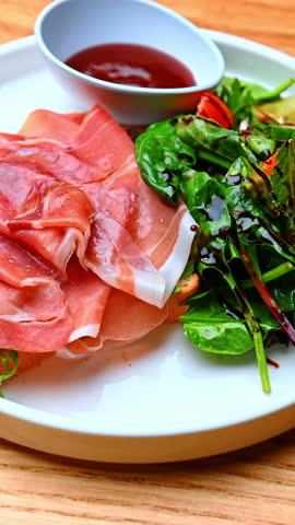 Ham toast with salad greens. Toasted bread with ham served beside fresh salad greens on a plate.