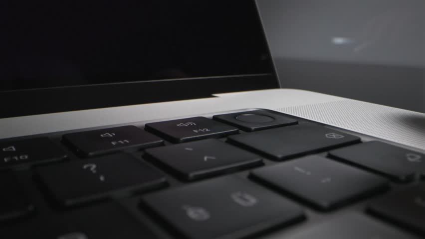 Pressing the fingerprint sensor on a laptop close up - Powered by Shutterstock - Get 15% off with code: PIKWIZARD15