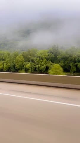 a very beautiful green foggy mountain