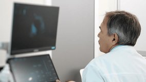 Medical doctor reviewing ultrasound scan results on monitor in modern clinic, diagnostic evaluation and healthcare imaging process indoors. - Powered by Shutterstock - Get 15% off with code: PIKWIZARD15