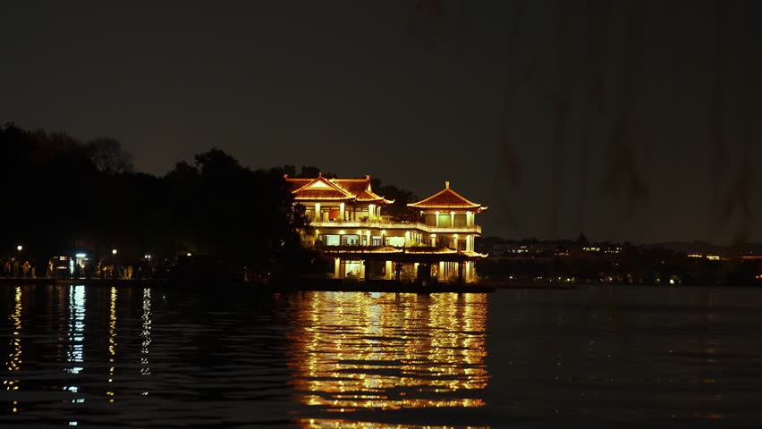 Traditional Chinese Pavilion Illuminated at Night on Lake West Lake