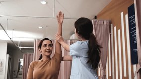 Hispanic female patient is arm stretching, treated health recovery, shoulder muscle pain relief by Asian physical therapist doctor, passive medical therapy at healthcare massaging wellness spa clinic. - Powered by Shutterstock - Get 15% off with code: PIKWIZARD15