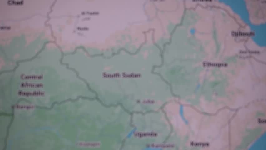 Magnified view of South Sudan on a map, highlighting Juba and surrounding borders, symbolizing war, crime, conflict and ongoing civil war challenges shaping the nation’s fragile political landscape.