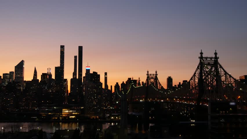 New York City Manhattan Midtown skyline from Queens, Queensboro bridge architecture, United States. Rooftop cityscape from Long Island Hunters Point. Urban sunset twilight dusk dark evening silhouette