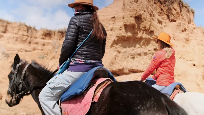 adventurers traverse rugged terrain along scenic mountain horseback paths beneath expansive skies, participants embark on scenic horseback journey through rocky landscapes and expansive sky vistas