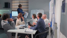 Office team engaged in tense discussion during business presentation. Male manager presents project ideas colleagues gesture in disagreement. Concept conflict, challenge, teamwork under pressure. - Powered by Shutterstock - Get 15% off with code: PIKWIZARD15