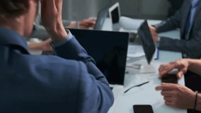 Group of professionals working intensely to finish a project before the deadline. Urgent meeting with laptops, and rapid discussion. Business people under time pressure making last-minute decisions.. - Powered by Shutterstock - Get 15% off with code: PIKWIZARD15