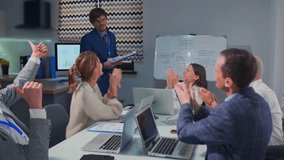 project team celebrates approval with lively discussions and teamwork, group of professionals congratulates presenter amid engaging discussions and collaborative planning in modern conference room - Powered by Shutterstock - Get 15% off with code: PIKWIZARD15