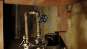 Close-up of a plumber’s hand adjusting a valve on a copper water pipe system, showing plumbing, maintenance, and repair work. - Powered by Shutterstock - Get 15% off with code: PIKWIZARD15