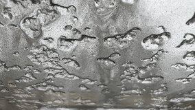 Macro view of a textured metal surface covered with scattered water droplets, creating irregular shapes and reflective patterns in a minimal industrial style.
 - Powered by Shutterstock - Get 15% off with code: PIKWIZARD15