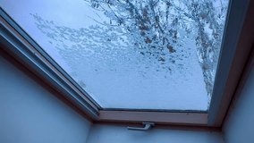 Close-up view of a window covered with a thin layer of snow and frost, forming intricate crystalline patterns on the glass surface in a cold winter setting.
 - Powered by Shutterstock - Get 15% off with code: PIKWIZARD15