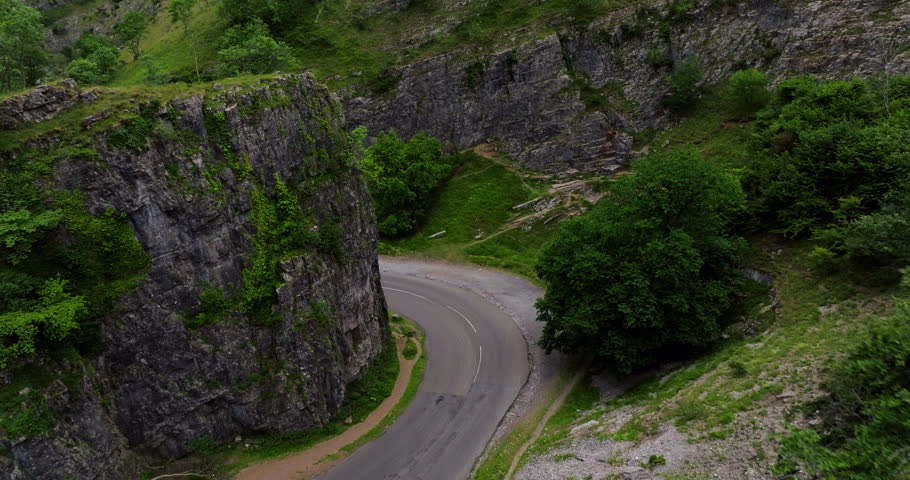 The Main Road Running Through Cheddar Gorge Limestone Cliffs In Somerset, England. Aerial Shot