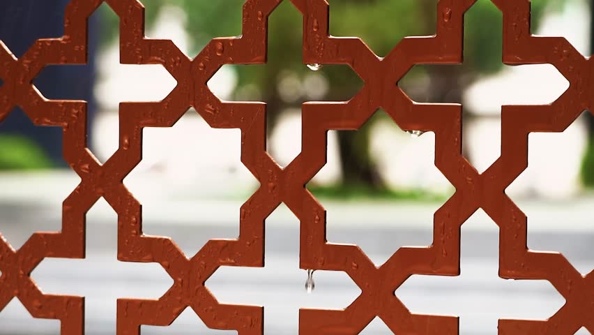 Rusty iron decor, Closeup of aged metal lattice with vibrant greenery in background, Intricate wrought iron screen with aged paint and peaceful garden setting illuminated softly - Powered by Shutterstock - Get 15% off with code: PIKWIZARD15