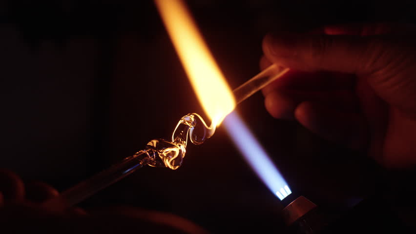 Creating melting flux flame for smelting process in evening workshop