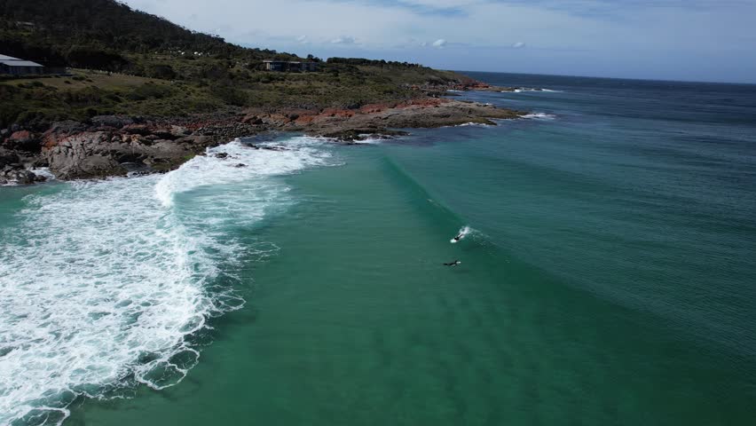 Surfers Riding The Waves At Little Beach Cove In Tasmania, Australia - Drone Shot