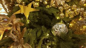 A warm, festive Christmas tree scene featuring gold ornaments, twinkling lights, and a gold star, creating a luxurious holiday ambiance perfect for family celebrations and seasonal decor. - Powered by Shutterstock - Get 15% off with code: PIKWIZARD15