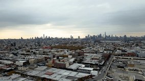 Dusk aerial flying toward Brooklyn buildings with colorful skies and lights beginning to glow across rooftops. A perfect blend of architecture, sunset ambiance, and urban energy. - Powered by Shutterstock - Get 15% off with code: PIKWIZARD15